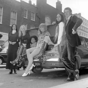 A 1970 Pirelli calendar print features a racing driver with five models A 1970 Pirelli calendar print features a racing driver with five models