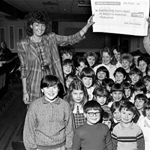 Miss Examiner Madeleine Garbutt (left) is presented with a £1