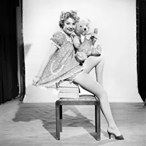 Model Audrey Nicholson wearing nightee seen here with her Teddy bear. 1959