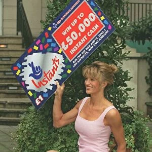 Model Paula Hamilton holds up the National Lottery Instants card