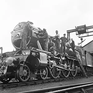 Mr Alan Pegler and his crew of volunteers pictured cleaning The Flying Scotsman Engine