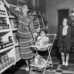 Mrs Freda Fox seen here selecting a jar of jam from the shelves of the new self service