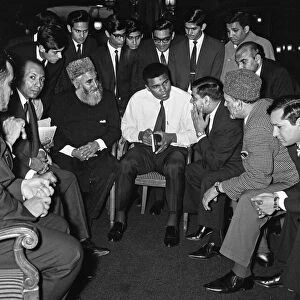 Muhammad Ali (Cassius Clay) speaking to Muslims holding a book called Towards