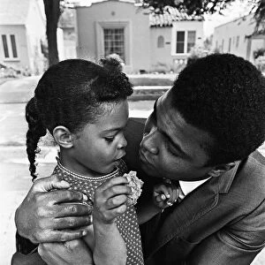 Muhammad Ali hugs a young fan. 31st August 1967