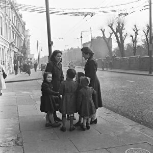 Mums and children gather on a corner of the Harrow Road close to the Regent Canal