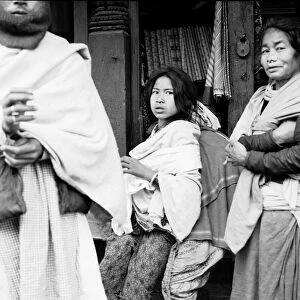 Nepalese women wearing a Tamang Nose-Rings seen here outside in a silk shop in a