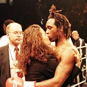 Nigel Benn kisses his girlfriend after his defeat by Steve Collins for WBO super