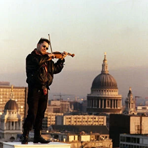 Nigel Kennedy the violinist playing his violin overlooking London