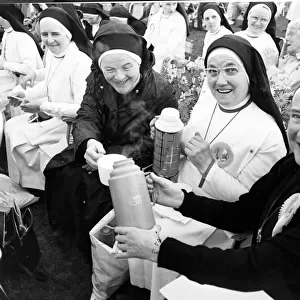Nuns - Nuns enjoy a cup of tea from their flasks whilst they wait to see the Pope during