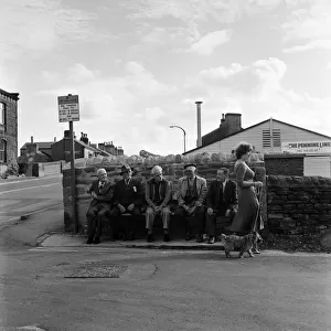 Old boys watch the girls go by from the bench at the junction of Keighly Road, Silsden