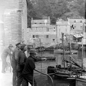 Old fishermen gathered at Polperro harbour in Cornwall August 1929 Alf 150