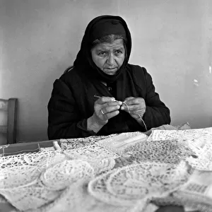 Old Greek Woman sewing lace at her stall in a Cyprus town market March 1952