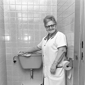 An old woman cleaning the toilet. November 1969 Z10818