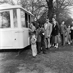 People buying refreshments in Kensington Gardens, London. 25th April 1955