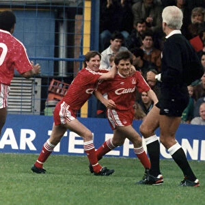 Peter Beardsley of Liverpool celebrating a goal with teammates Ronnie Whelan