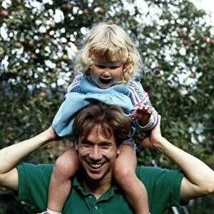 Peter Duncan TV Presenter with daughter on shoulders A©Mirrorpix