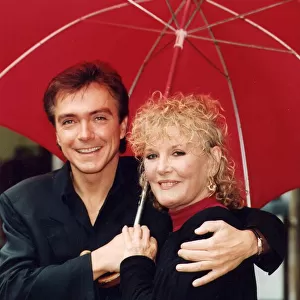 Petula Clark and David Cassidy under umbrella at photocall - July 1993