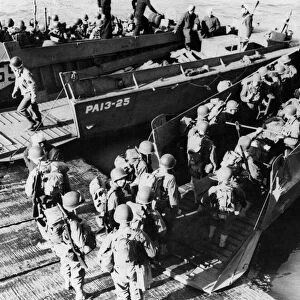 This picture shows American troops going aboard a landing craft during the successful