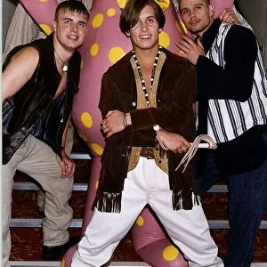 Take That Pop group standing on stairs with Mr Blobby