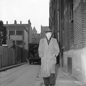 Portrait of boxer, Teddy Baldock, waking down a street. August 1956