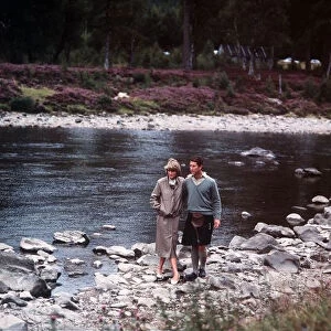Prince Charles and Princess Diana walk along the River Dee at Balmoral