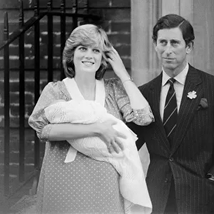 Princess Diana, the Princess of Wales holds her newborn baby son William with husband