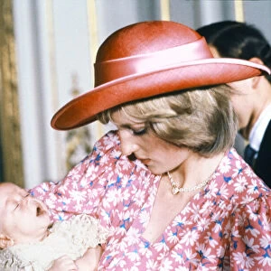 Princess Diana, watched by husband prince Charles, holds her son Prince William in her