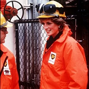 Princess Diana wearing a construction hard hat with protective ear guards