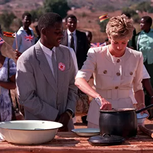 PRINCESS OF WALES DISHING OUT FOOD DURING A VISIT TO RED CROSS CHARITY PROJECT IN