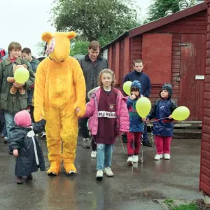 Pudsey Bear leads the toddlers round the park during the Great Toddle for Children in