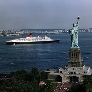 The QE2 Ship leaves New York Harbour past the Statue of Liberty April 1992