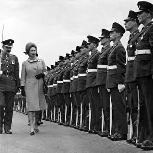 The Queen, accompanied by Major M Pim, inspects the Guard of Honour of the 1st Battalion