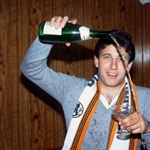 Ralph Milne pouring champagne from bottle January 1989