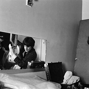 Ray Davies of The Kinks pop group rehearsing in their dressing room before a concert