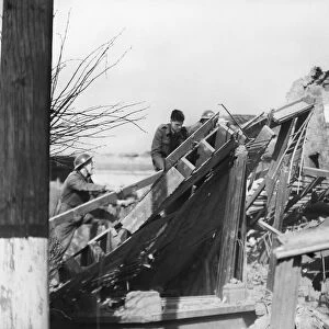 Rescue workers search the rubble of Audrey Road, Ilford, following a V2 missile attack