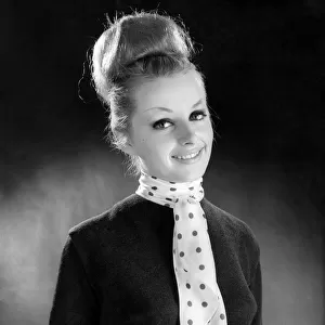 Reveille Fashions. Mannequinn modeling a scarf tied with a tie knot. January 1964 P007616
