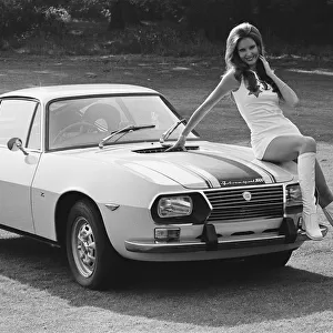 Reveille model Beulah Hughes seen here posing with a Lancia car which is a top prize in