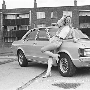 Reveille model Holly Davenport seen here posing with a Ford Consul which is top prize in