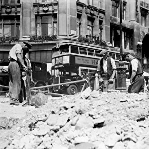 Road workers, digging up the road at Oxford Street, London