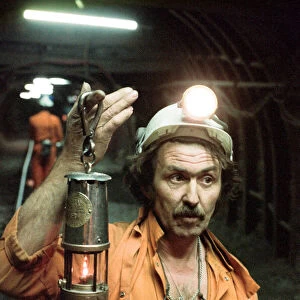 The last shift at Cotgrave Colliery, one of the last miners underground holds a Davy lamp