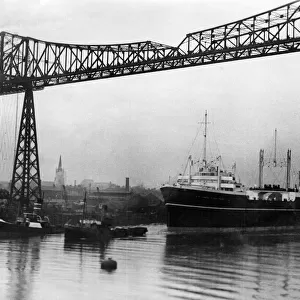 Ship is towed under the Tees Transporter Bridge, Middlesbrough, 1930