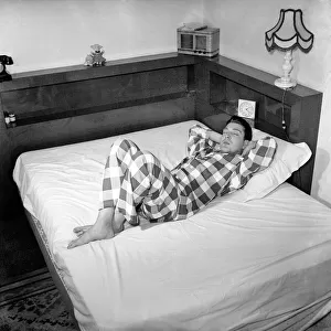 Singer David Hughes sleeping. December 1953 D7611