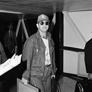 Singer Elton John, arrives at Heathrow airport from Australia