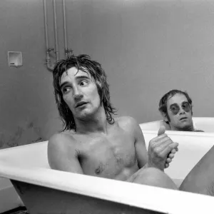 Singers Elton John and Rod Stewart having bath at Watford football ground