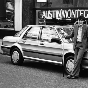 Snooker player Jimmy White poses beside a new model Austin Montego. 11th May 1984