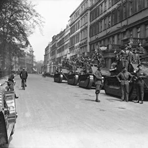 Soldiers wait by their Vickers Medium tanks, parked in Pont Street London