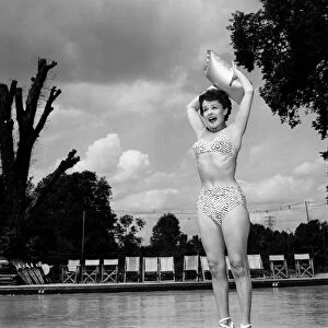 Stage and film actress Betty Paul wearing a bikini by the pool. July 1950 O25773
