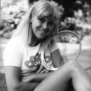 Sue Barker Tennis player sitting on grass holding tennis racket at Wimbledon