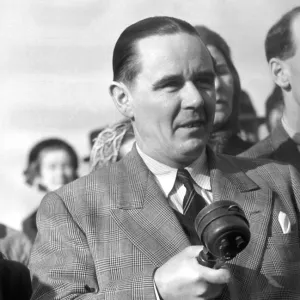 Sunday times golfing correspondant Henry Longhurst with microphone in hand at a meeting