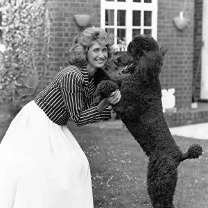Television presenter and news reader Jan Leeming at home with her dog